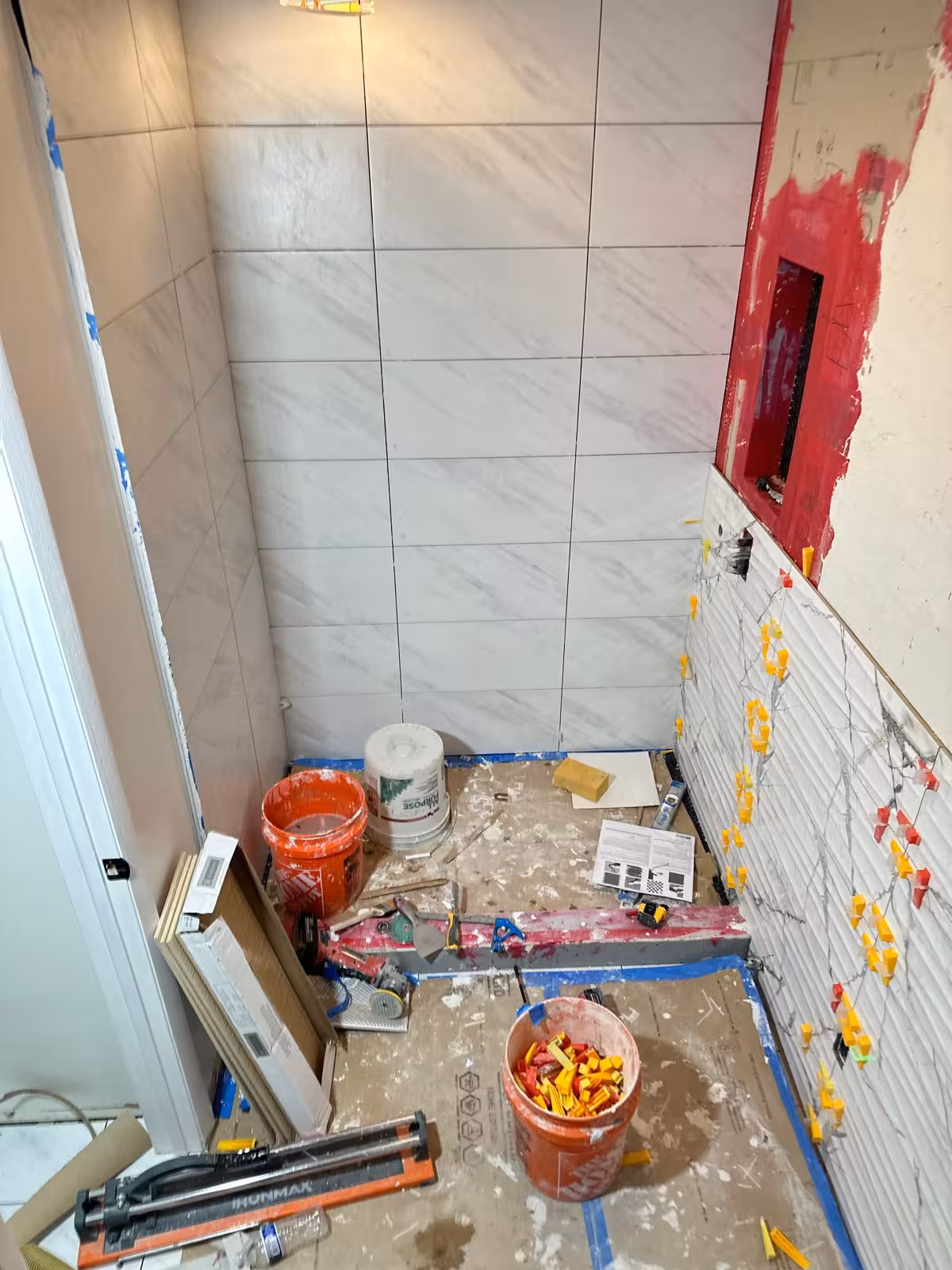 12x24 marble-look tile installation on shower back wall in Aurora