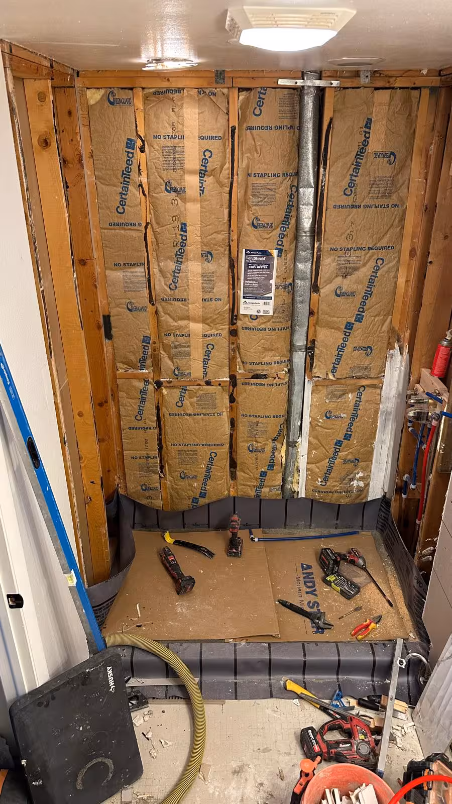 Open framing and custom shower pan preparation during Aurora tub-to-shower remodel