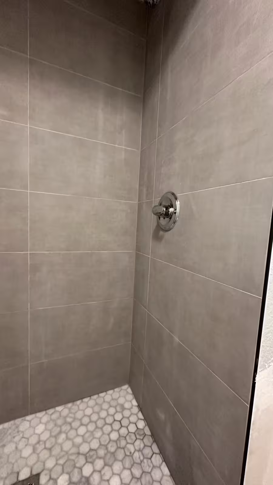 Finished control wall with large-format tile in rebuilt shower in Arvada CO