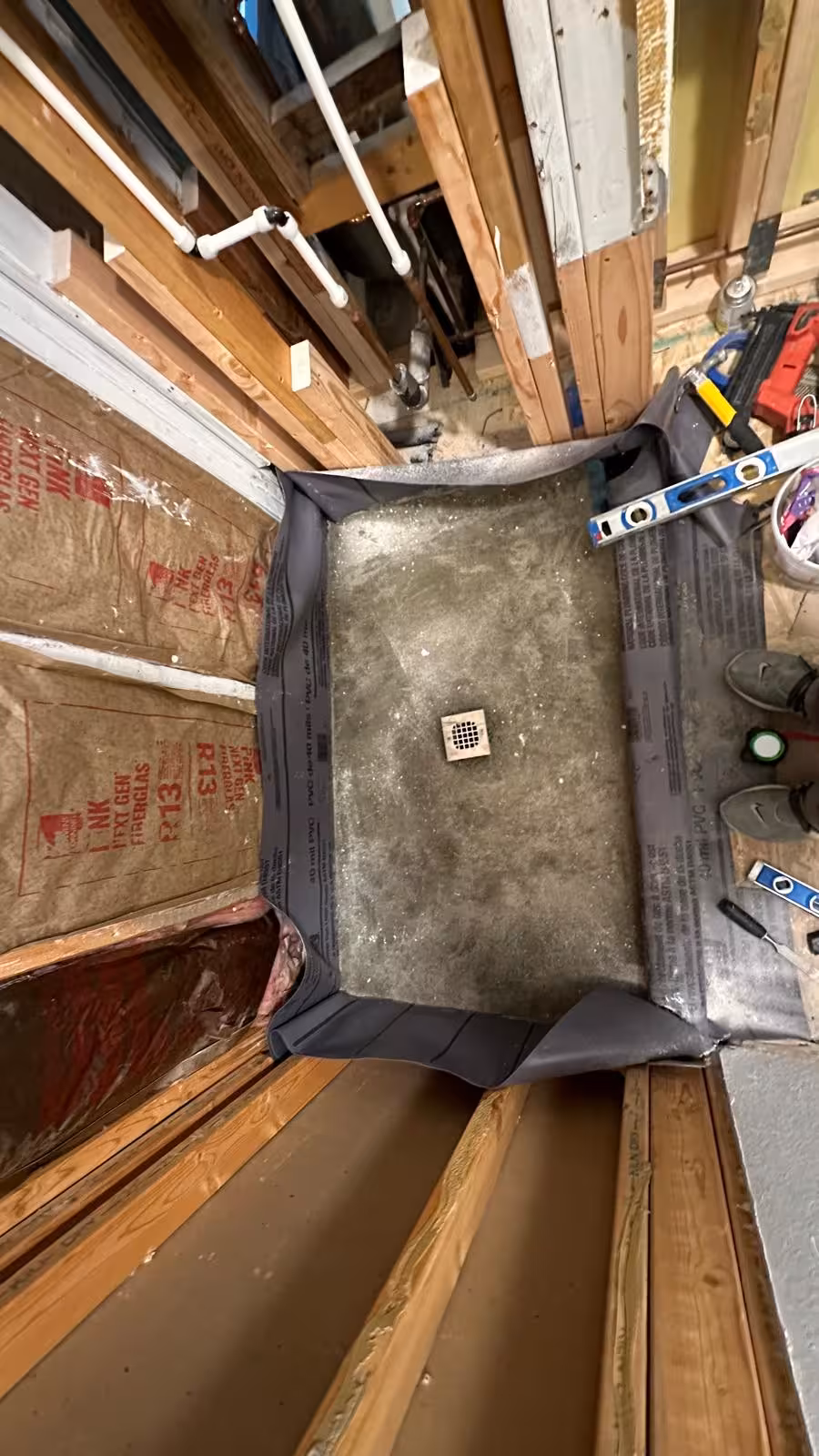 Custom liner-based shower pan base with centered drain under construction in Arvada Colorado