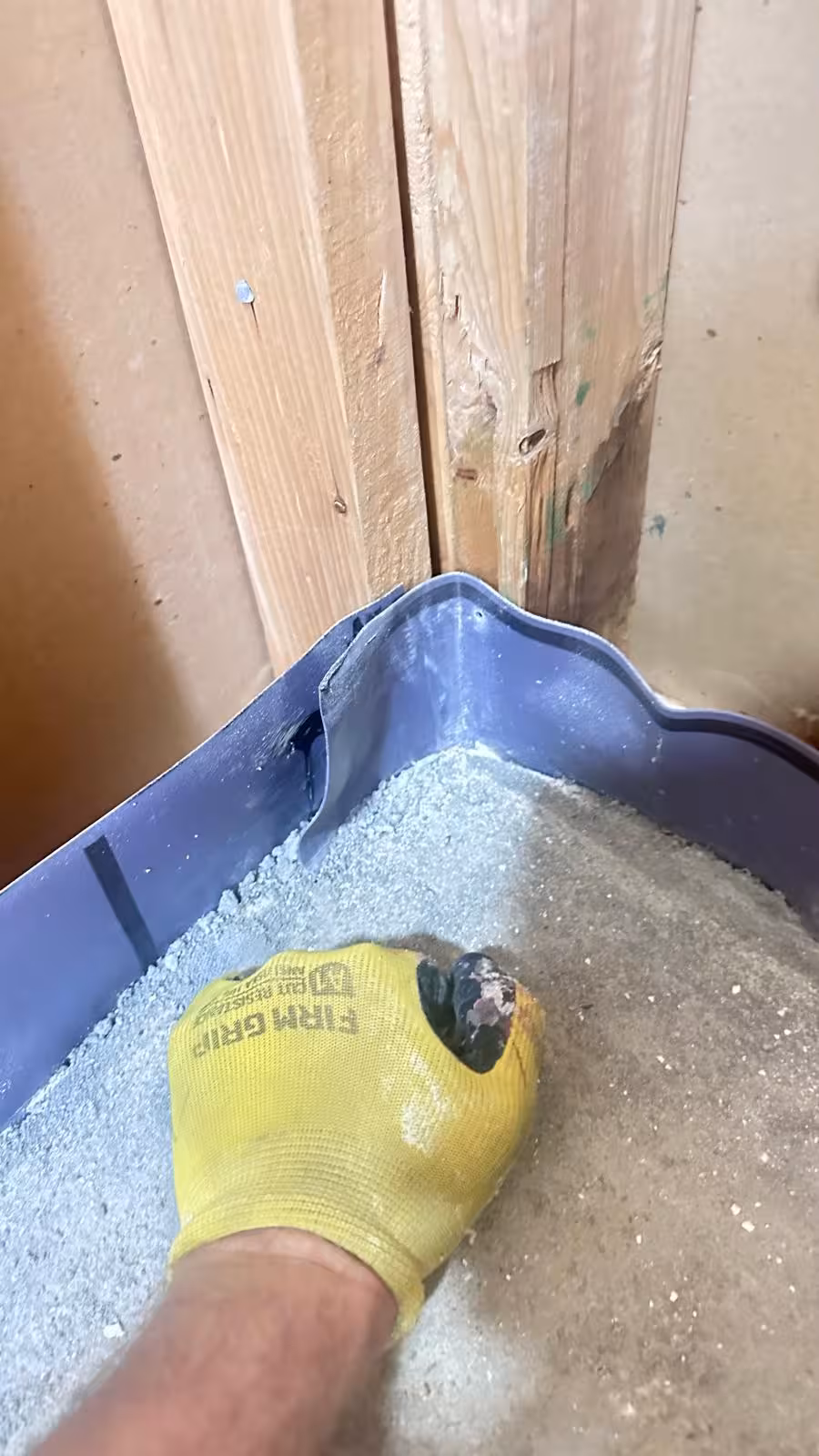 Shower pan liner corner being inspected in Denver CO showing improper fold