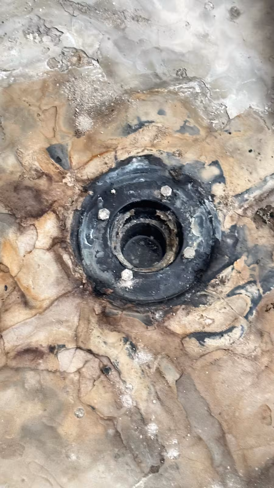 Old shower drain assembly exposed during leaking shower pan repair in DTC