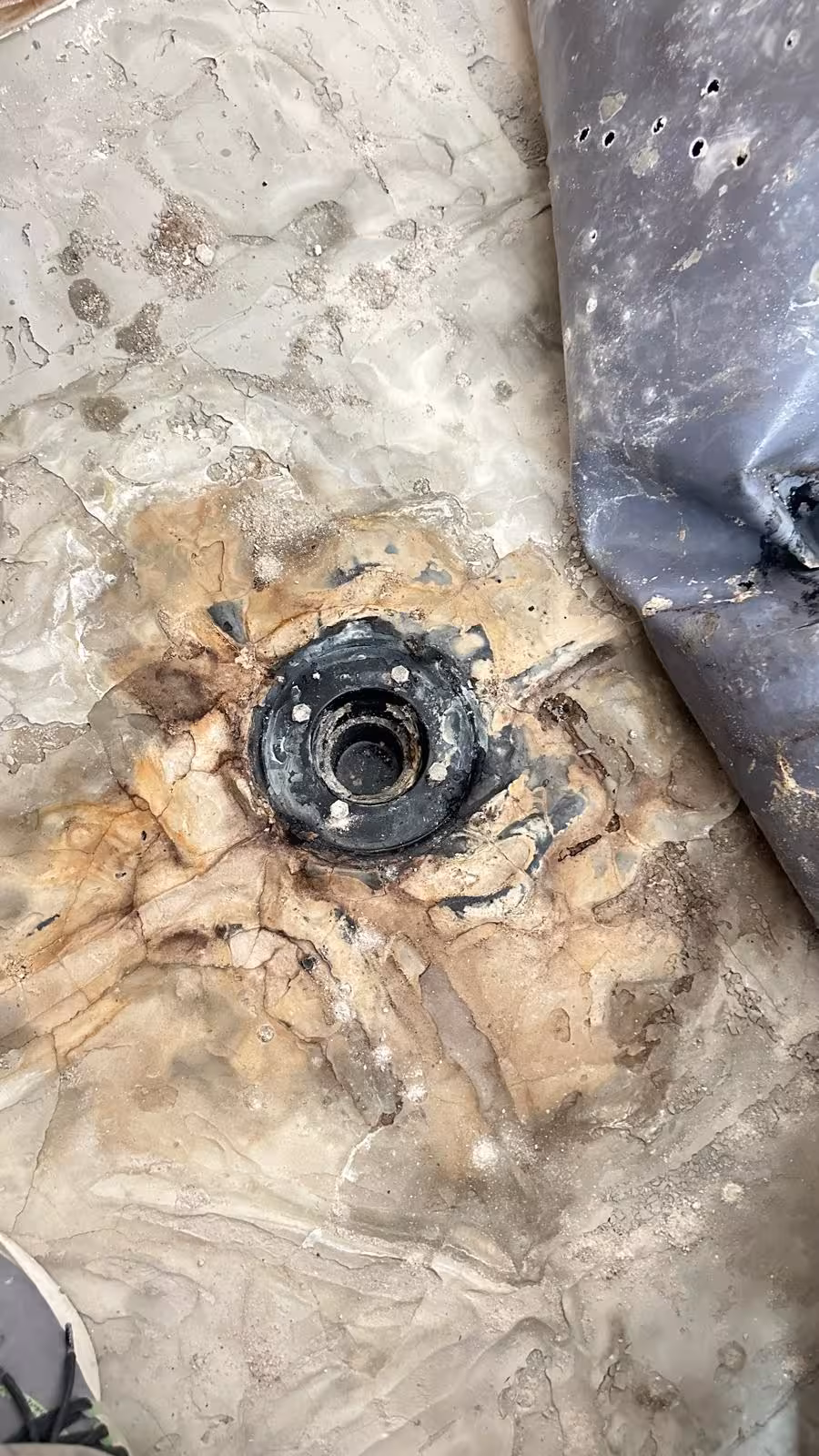 Water damage around shower drain before pan replacement in DTC