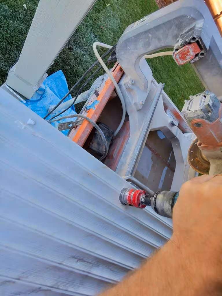 Drilling through tile with Milwaukee tool for fixture installation