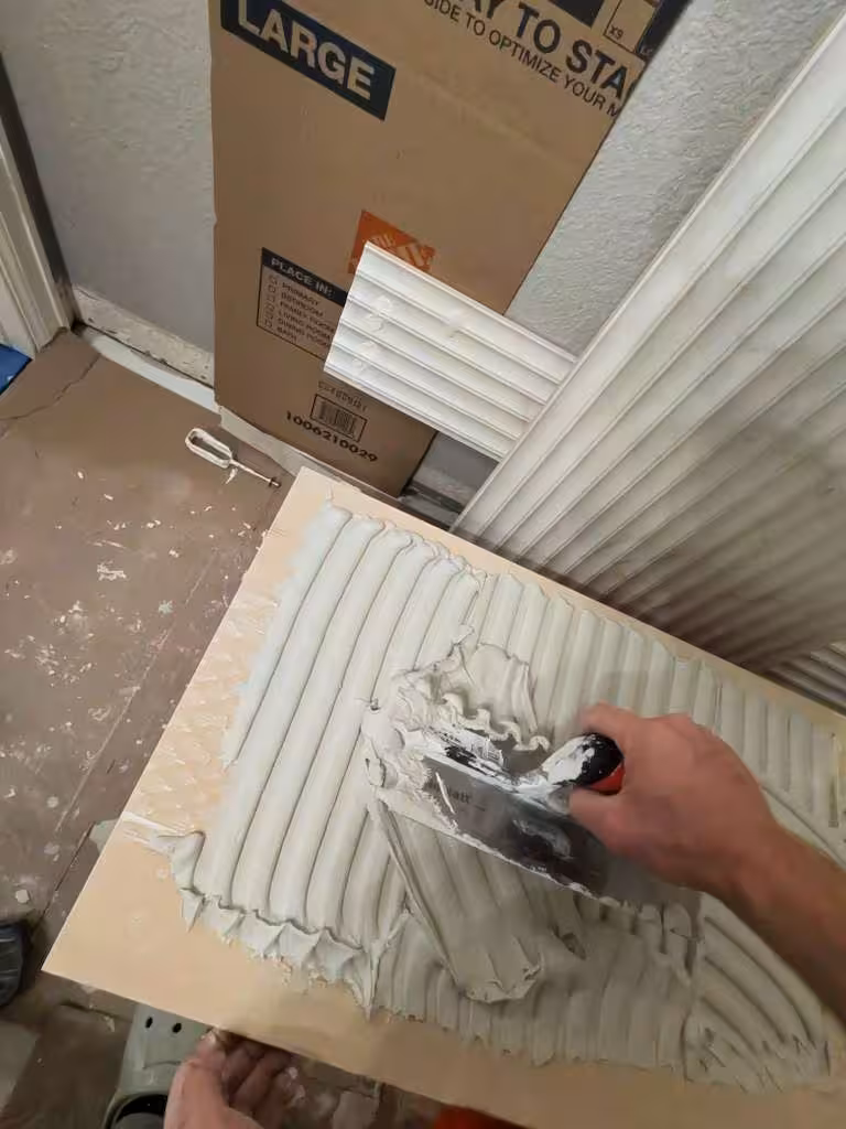 Spreading thinset mortar on tile backing with notched trowel