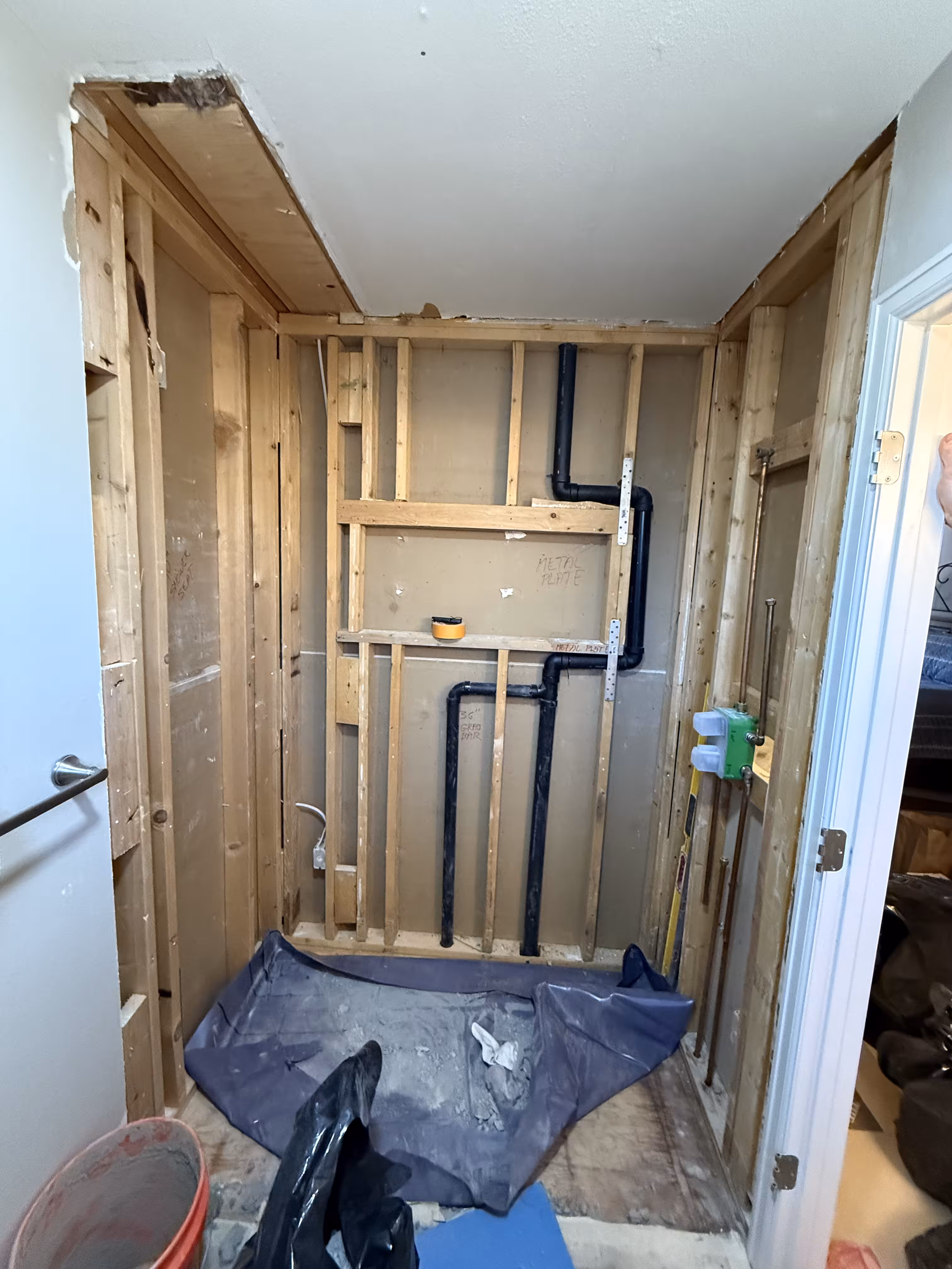 Open wall framing during shower remodel in Highlands Ranch CO after removal of failed shower pan