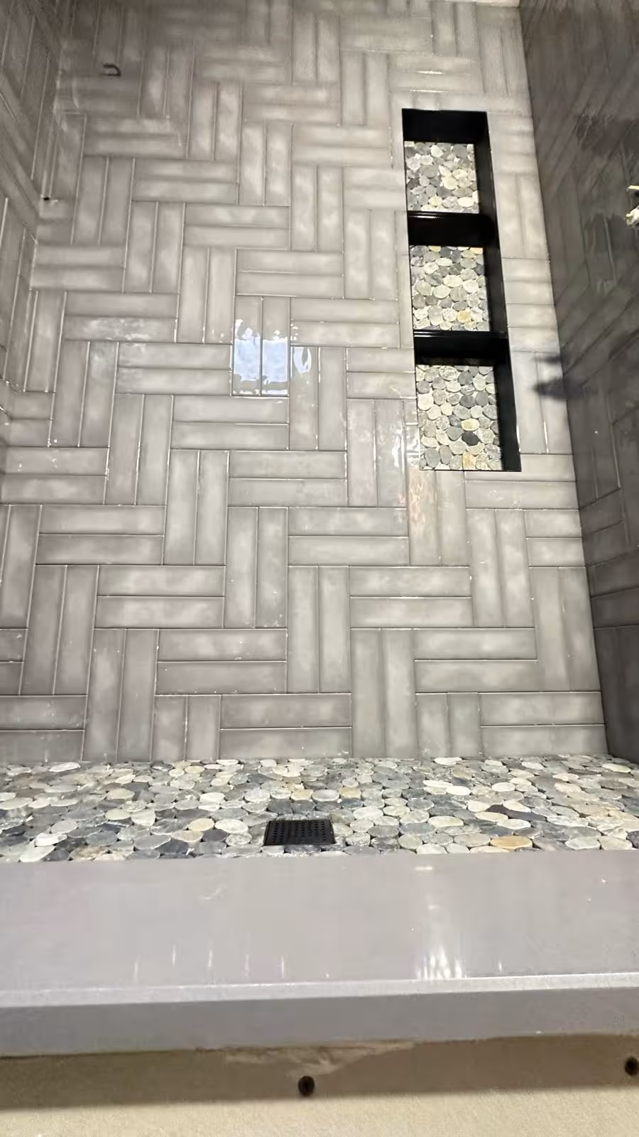 Large vertical shower niche with dual dividing shelves for bathroom storage Littleton designer bathroom