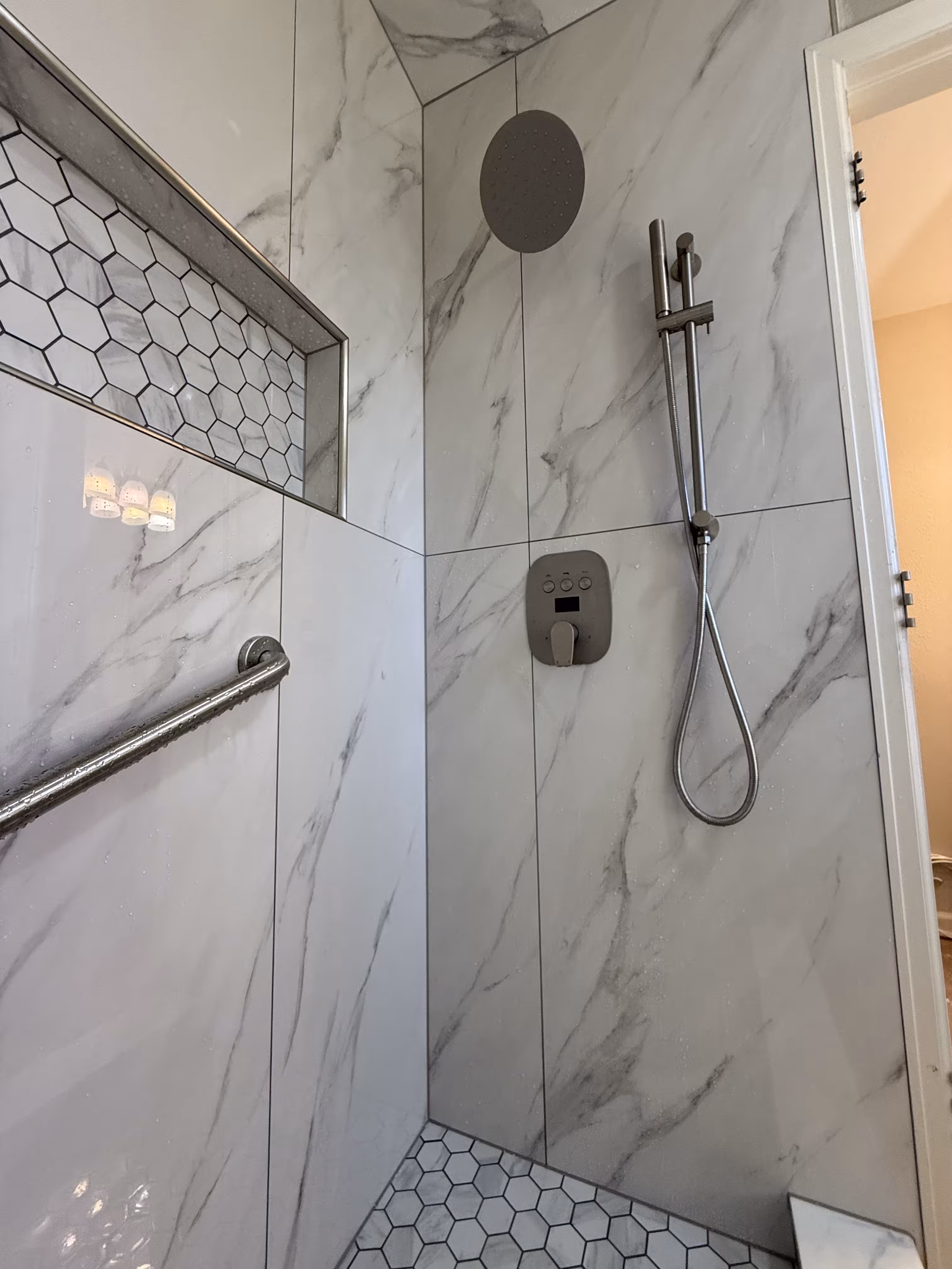 Finished Highlands Ranch shower remodel with digital thermostatic controls and marble-look tile walls