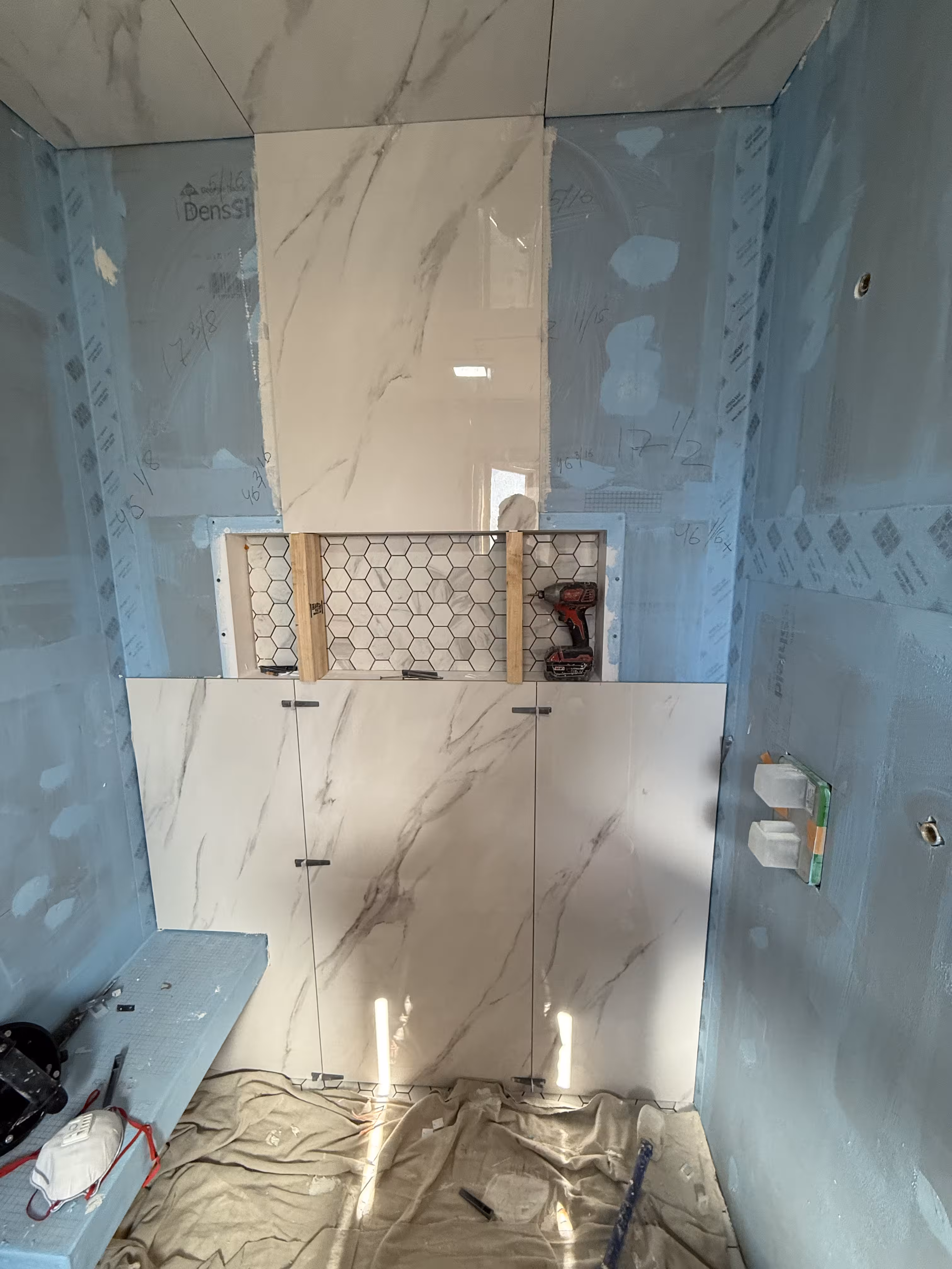 Shower niche and floating bench preparation during waterproof tile shower installation