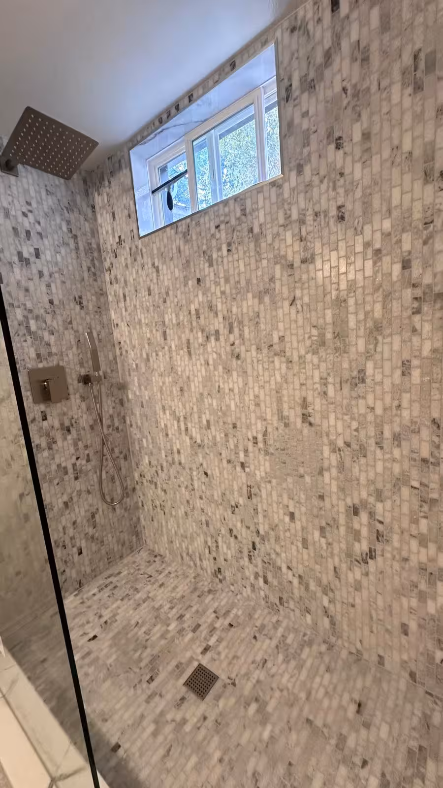 Complete basement bathroom full view with marble mosaic shower and toilet Littleton