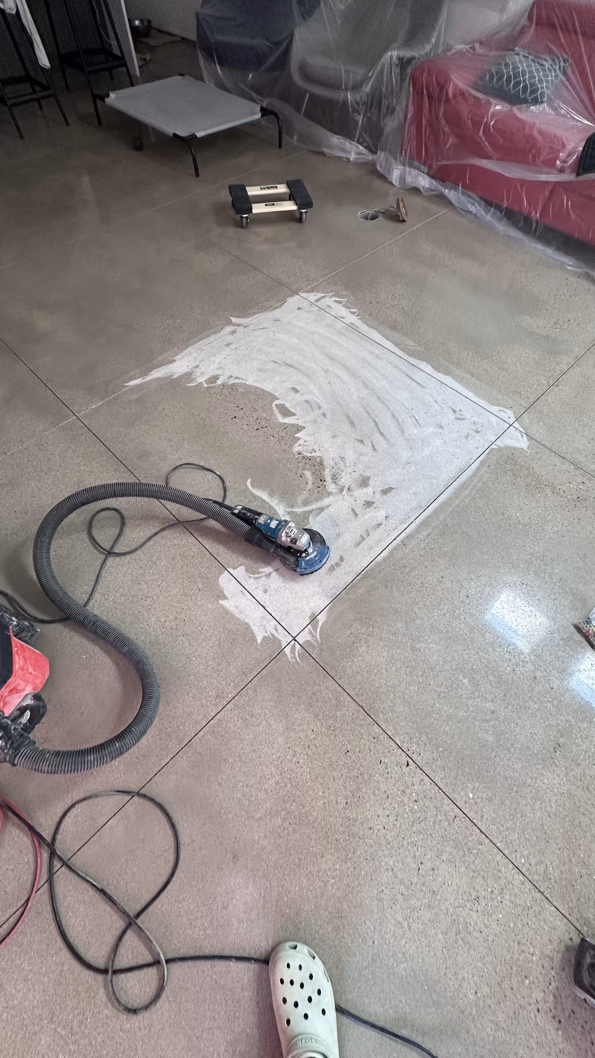 Hand grinding to remove lacquer from concrete floor in Denver