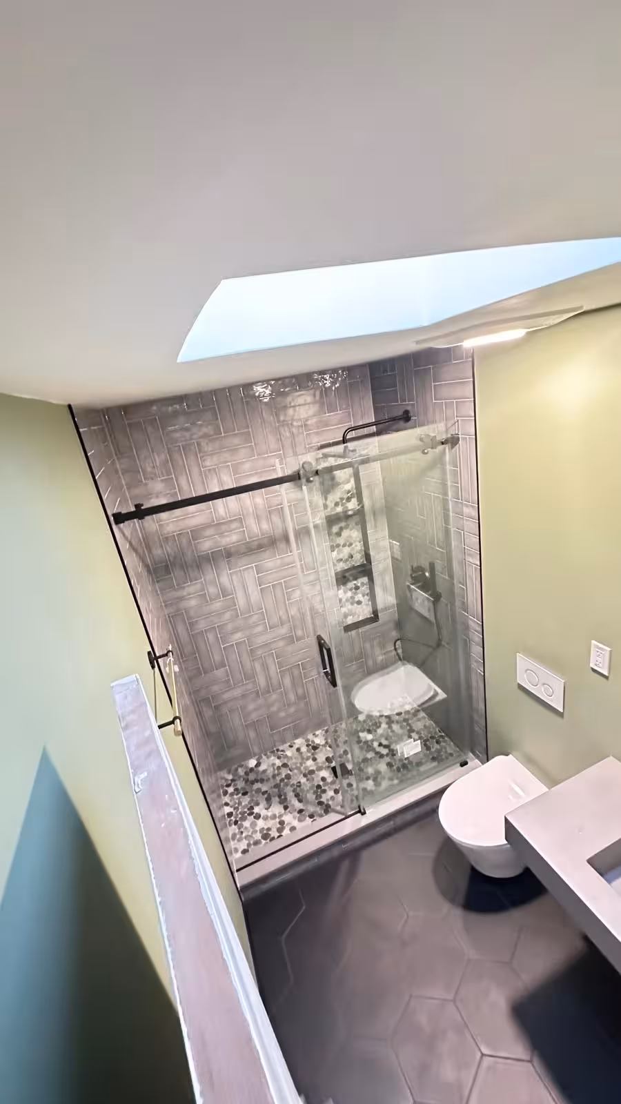 Complete view of Littleton designer bathroom remodel with wall-hung toilet and custom tilework