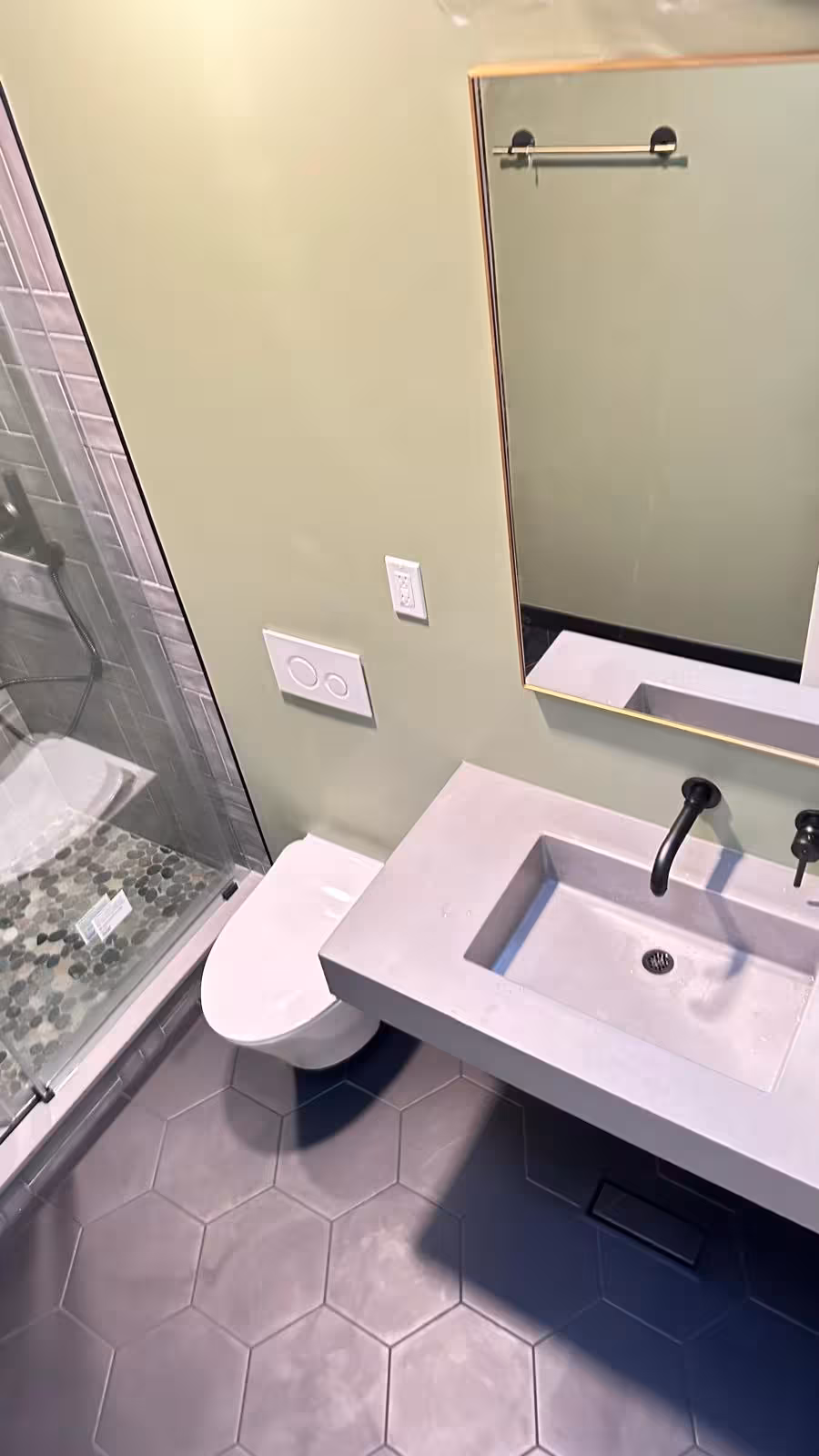 Compact bathroom remodel with skylight natural lighting and modern tile design Littleton Colorado