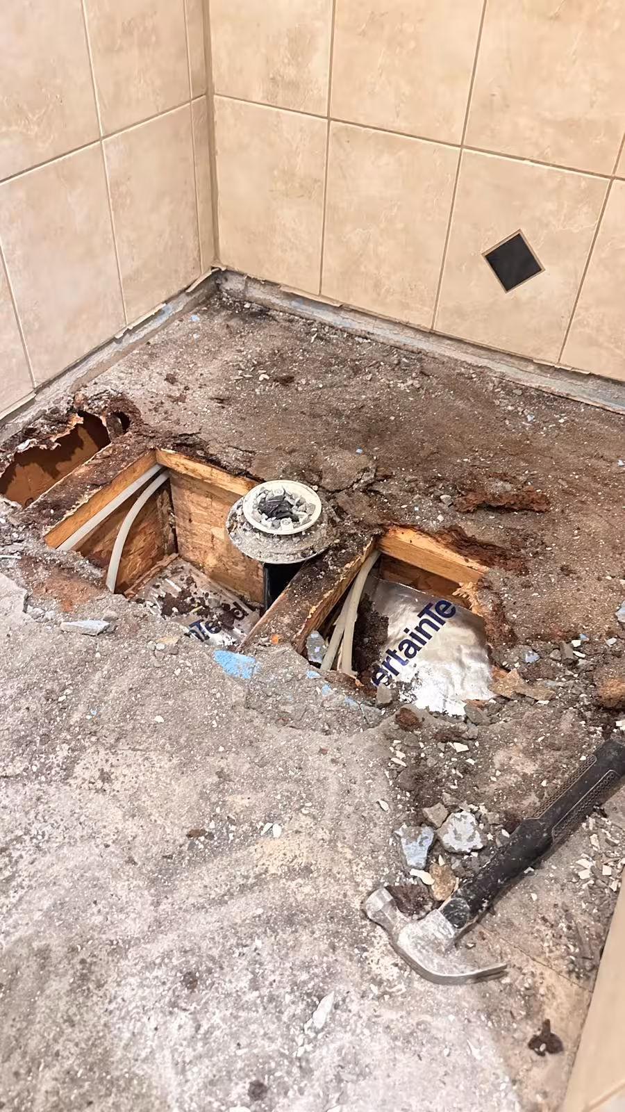 Complete demolition with exposed floor joists during damage assessment Elizabeth Colorado shower repair