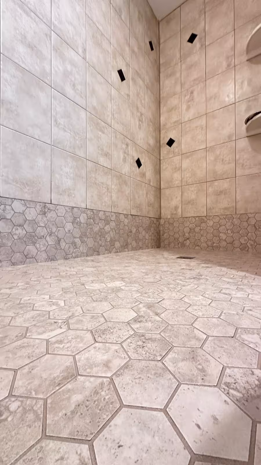 Close-up of hexagon mosaic tile floor installation on rebuilt shower pan Elizabeth CO