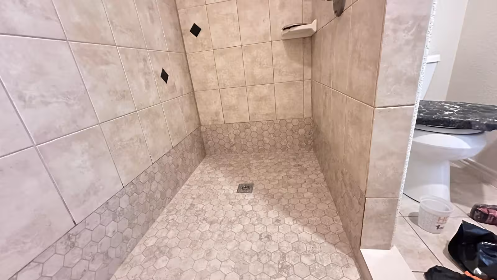 Renovated shower interior with showerhead and new tile installation Elizabeth Colorado