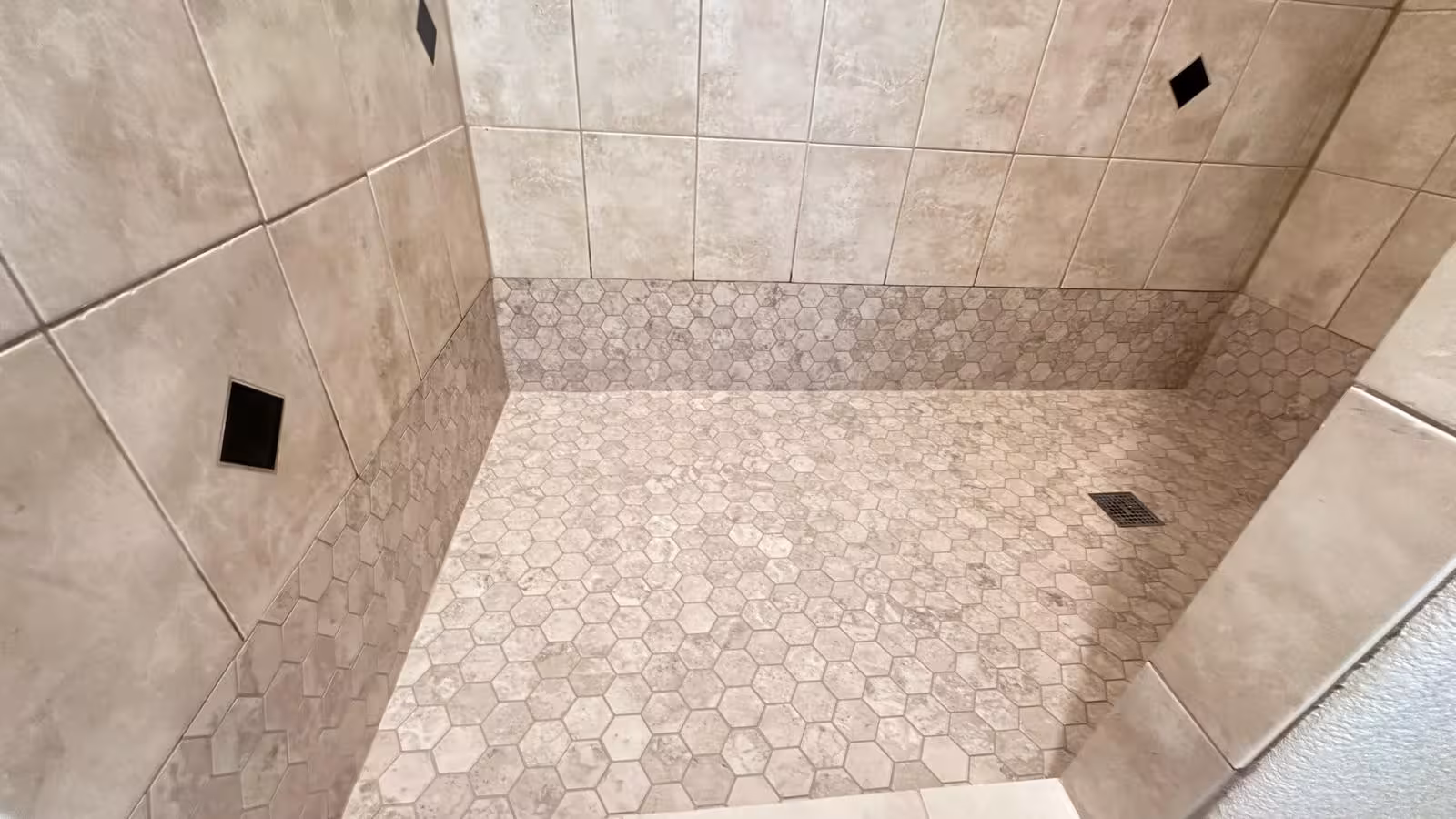 Hexagon mosaic tile floor detail showing professional installation Elizabeth Colorado shower repair
