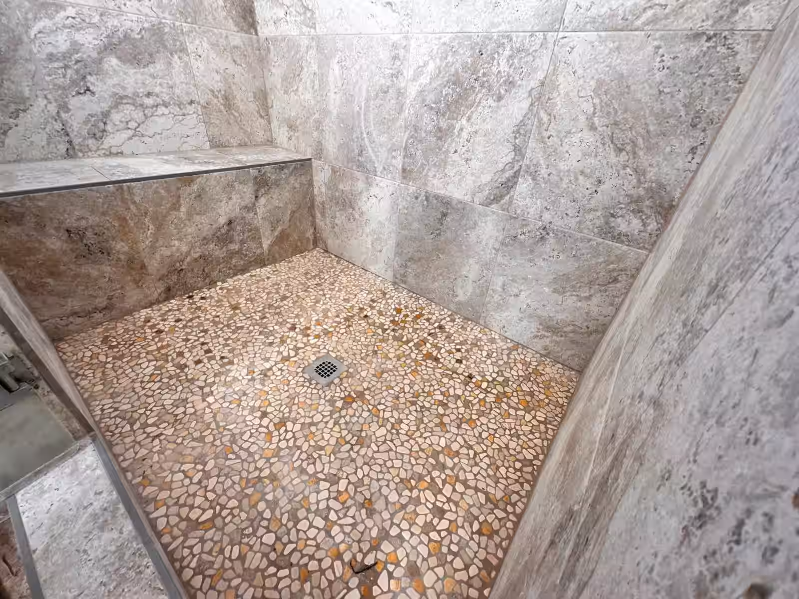 Custom shower with natural pebble stone floor tile installation finished