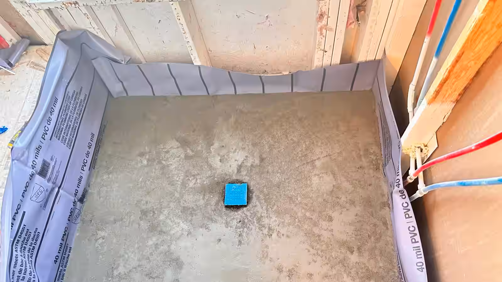 Shower pan waterproof liner installation in final stage before tile