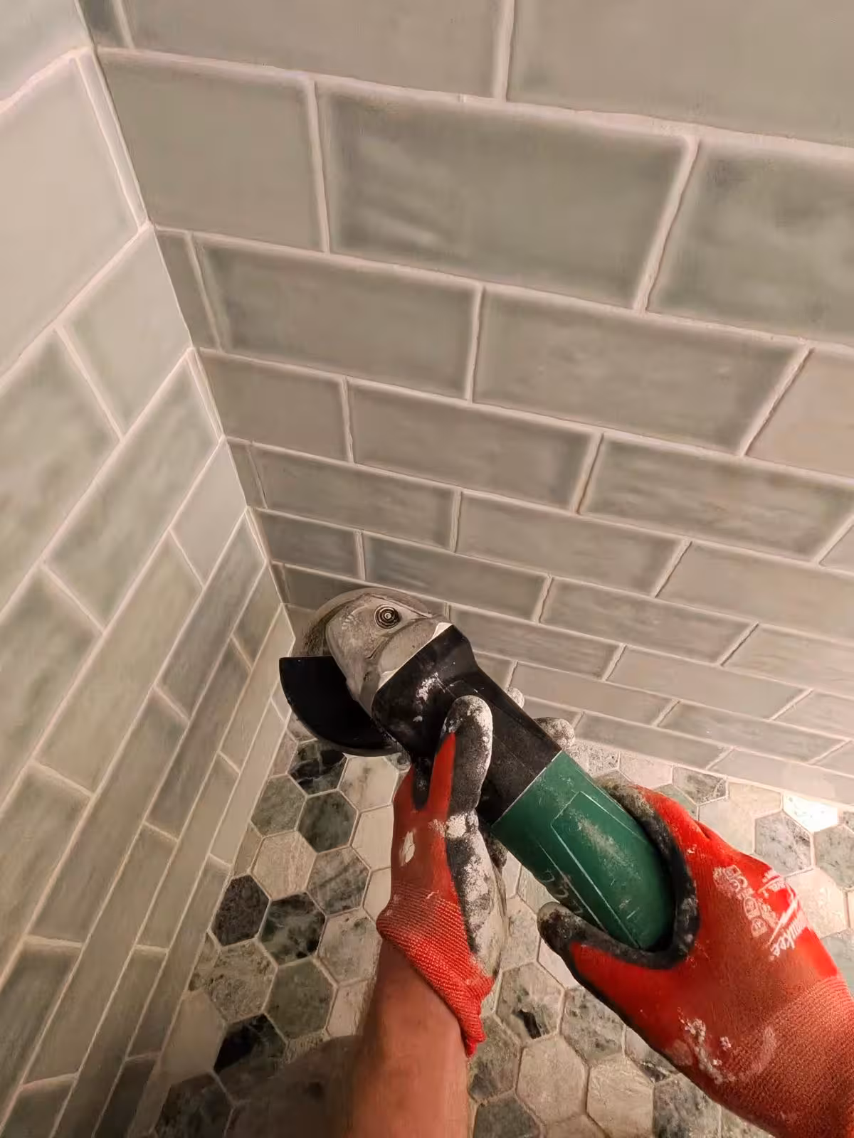 Using angle grinder for tile removal during shower pan repair Denver