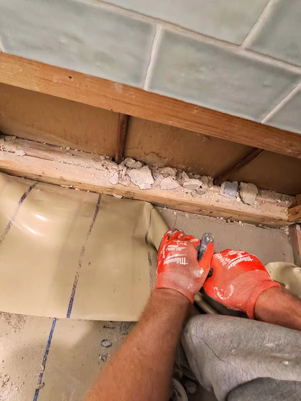 Shower pan floor joist inspection from below during leak diagnosis Denver