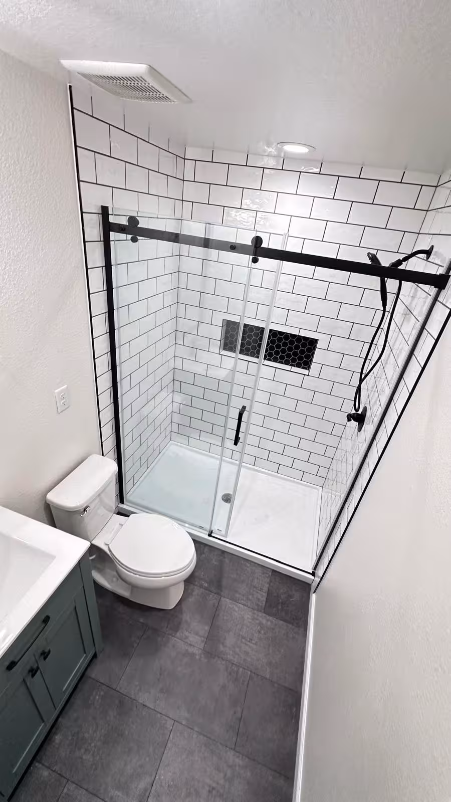 Contemporary bathroom with walk-in shower and black-framed glass door